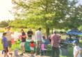 Group of people attending an outdoor event in a park