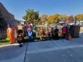 Kramer Homes Halloween party children in costume lined up in front of a fence for the picture